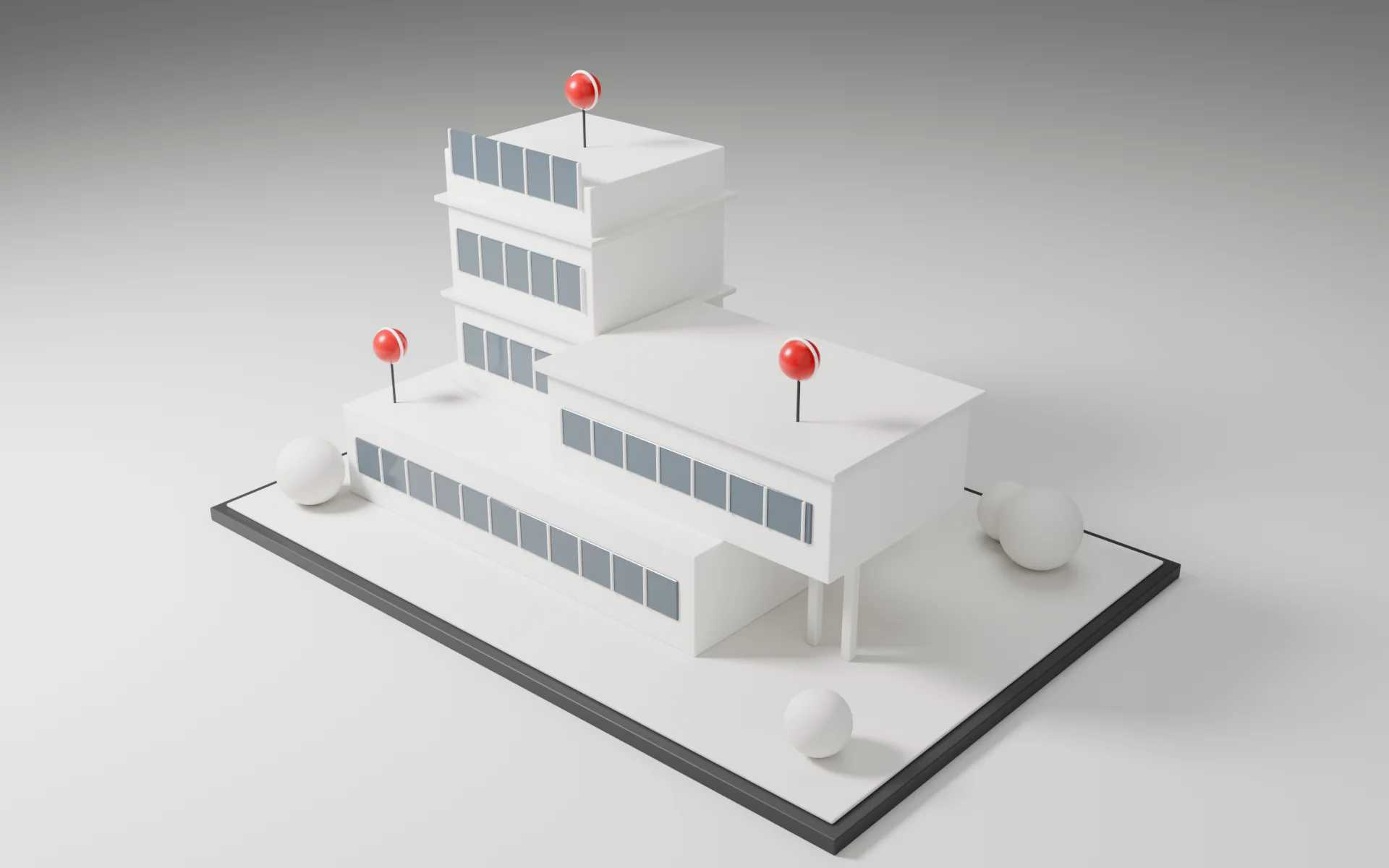 White architectural model with red markers on a studio plinth